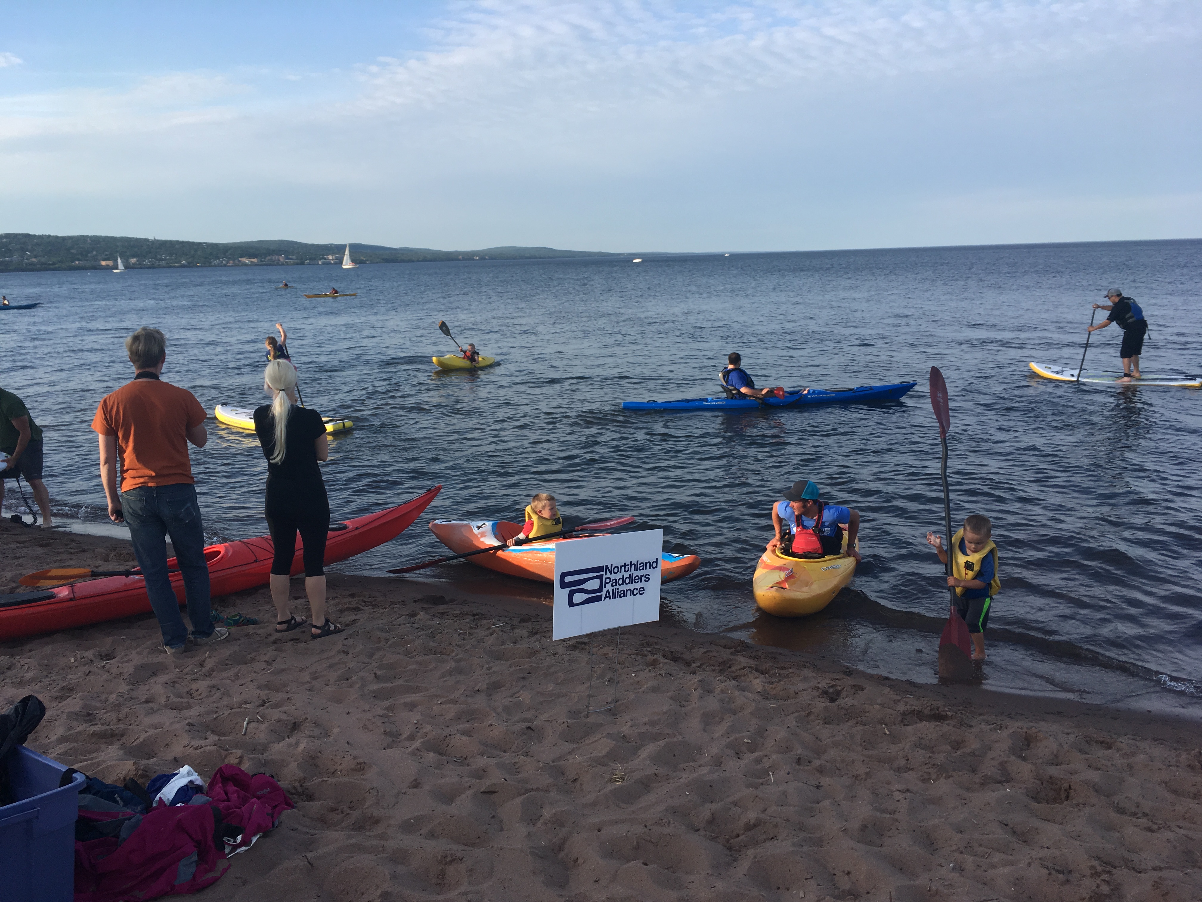 Group community paddle on calm water near Duluth